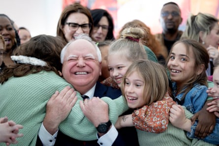 children hug a governor who just signed a bill guaranteeing them free school meals