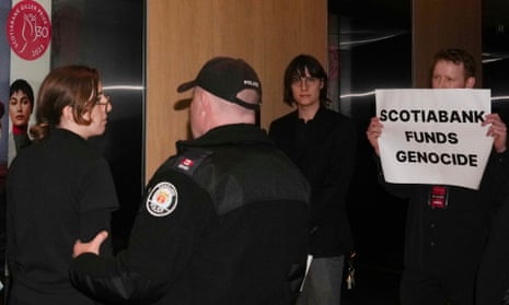 Protesters are escorted out of the Four Seasons Hotel by police