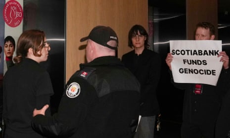 Protesters are escorted out of the Four Seasons Hotel by police 