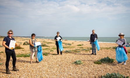 Volunteers participate in a beach litter clean-up in Cornwall.