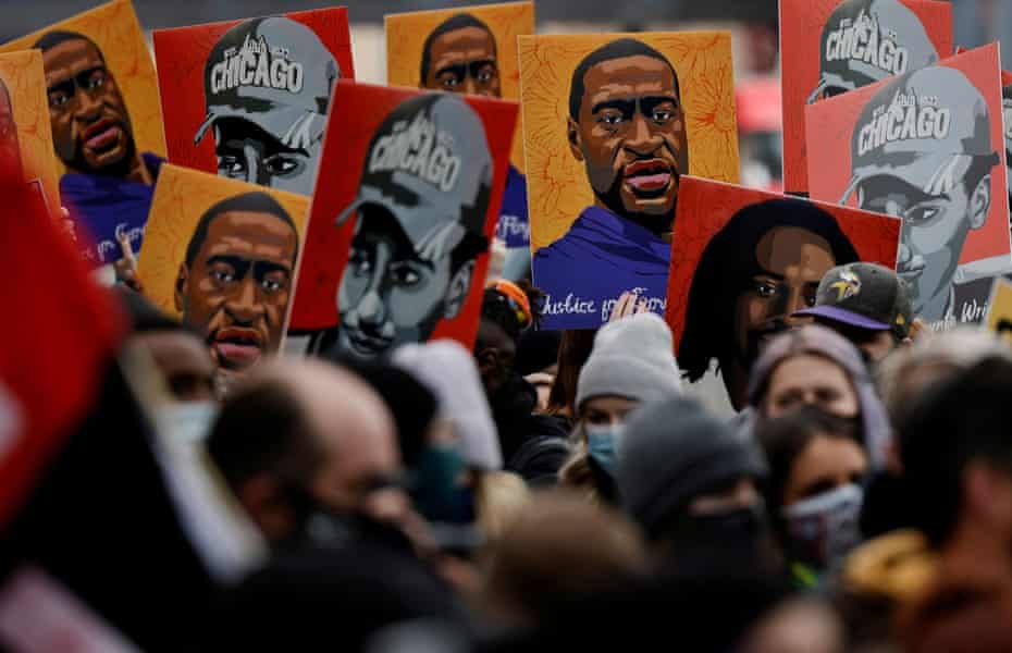 People hold placards with paintings of George Floyd, Daunte Wright and Philando Castile, all killed by Minneapolis-area police, after the verdict in Derek Chauvin’s trial.