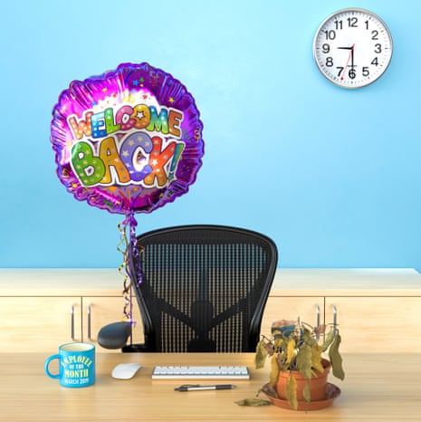 An office chair behind a desk with a colourful helium balloon attached to it saying 'welcome back!'