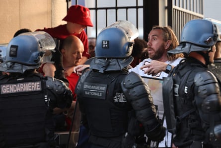 Fans are held back by the French gendarmerie.