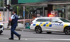 An armed police officer walks on patrol in a cordoned downtown area on 20 July 2023