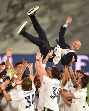 Zinedine Zidane is thrown up in the air by his players