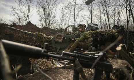 A Ukrainian serviceman operates an anti-air gun near Bakhmut to defend the town from Russian forces.