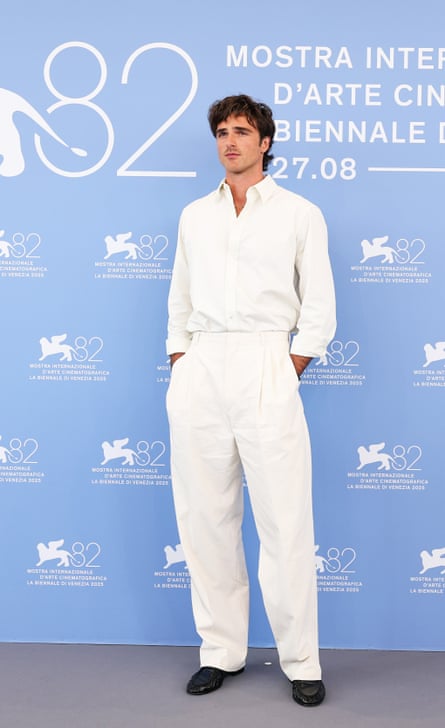 Jacob Elordi in a white shirt and matching trousers with black shoes