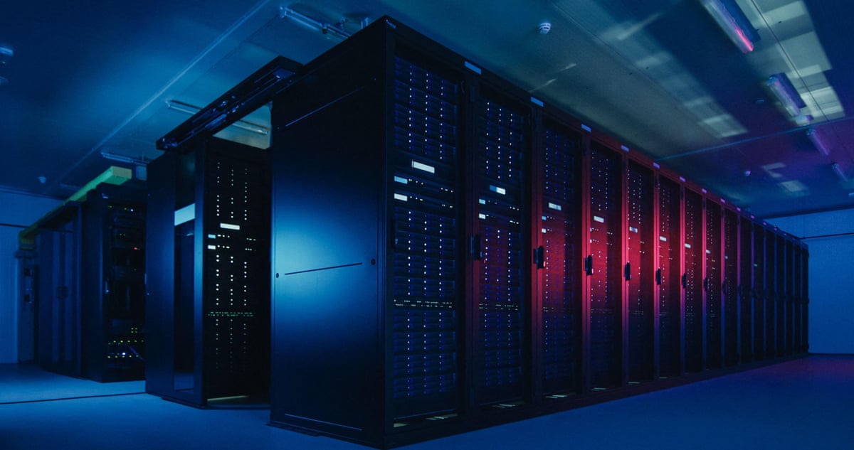 A datacentre with multiple rows of fully operational server racks.