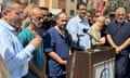 Palestinian doctor Muhammad Abu Salamiya stands with a group of men behind a lectern