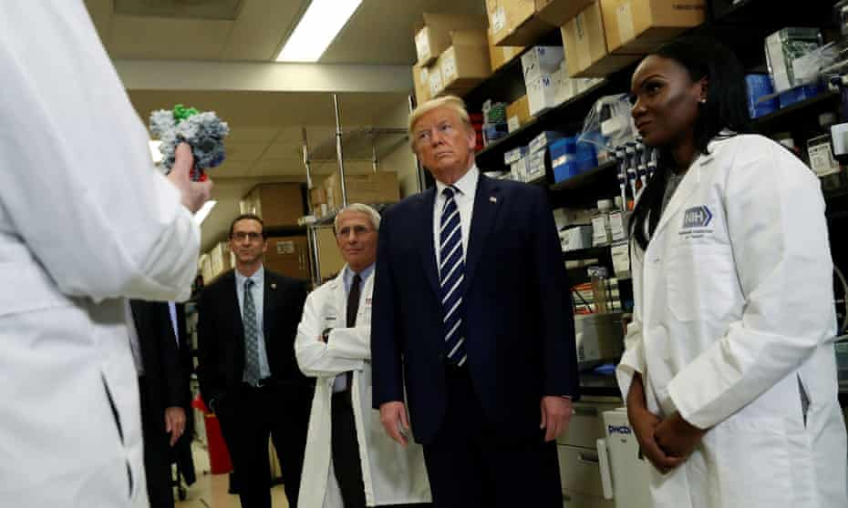 Dr Kizzmekia Corbett, right, a research fellow at the NIH vaccine research center, in Bethesda, Maryland, with Donald Trump in March.