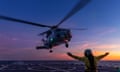 A helicopter landing on the Australian destroyer HMAS Hobart