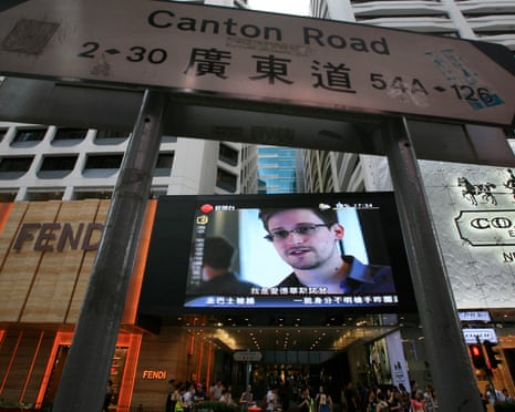 FILE - In this June 23, 2013 file photo, a television screen shows a news report of Edward Snowden, a former CIA employee who leaked top-secret documents about sweeping U.S. surveillance programs, at a shopping mall in Hong Kong. Whisked out of a luxury Hong Kong hotel, vanishing into a mysterious wing of the Moscow airport, Edward Snowden's continent-jumping, hide-and-seek game seems like the stuff of a pulp thriller \_ a desperate man's drama played out before a worldwide audience trying to decide if he's a hero or a villain. But the search for the former National Security Agency contractor who spilled government secrets has become something of a distracting sideshow, some say, overshadowing at least for now the important debate over the government s power to seize the phone and Internet records of millions of Americans to help wage the war on terrorism. (AP Photo/Vincent Yu, File )