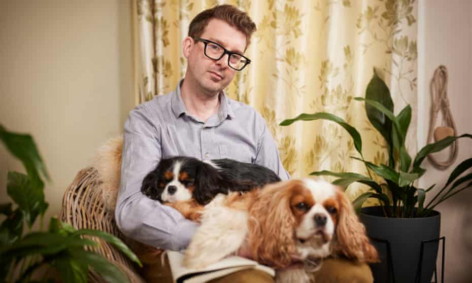 Simon James Green at home with his dogs in south London.