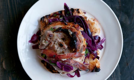 An open-faced roast pork and red cabbage sandwich on a plate