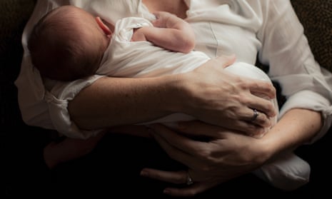 Mother holding newborn baby in arms
