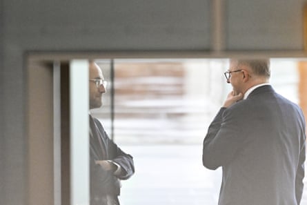 Anthony Albanese and Adam Bandt talking in parliament house