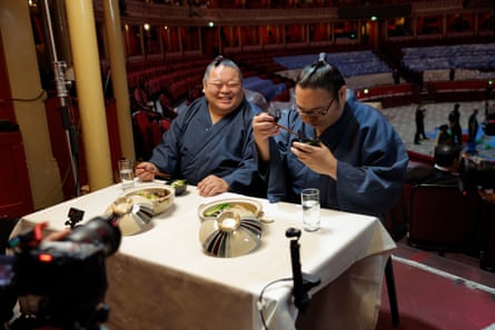 Dairaido (left) laughs with fellow rikishi Oginosho before eating a traditional hearty Japansese broth of chankonabe