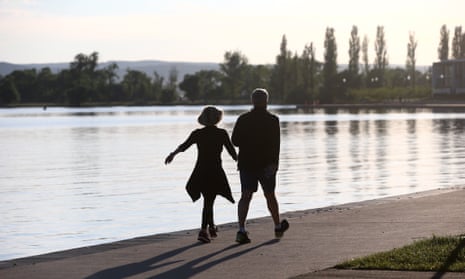 Former Sydney lord mayor Lucy Turnbull and prime minister Malcolm Turnbull walk around Lake Burley Griffin in Canberra.