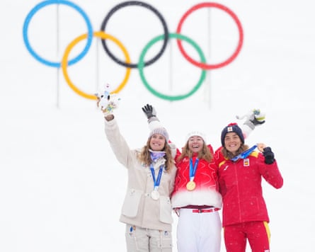 Marianne Fatton of Switzerland, Emily Harrop of France, and Ana Alonso Rodriguez of Spain pose for photos during the medal ceremony of the ski mountaineering women’s sprint event at the 2026 Winter Olympics