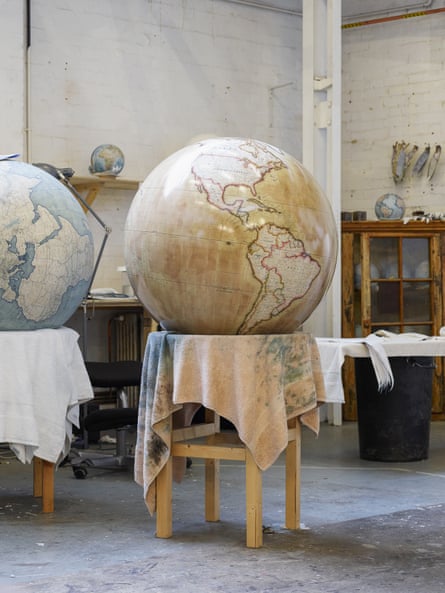 A globe that has been painted dries on a stand at Bellerby & Co, north London, UK.