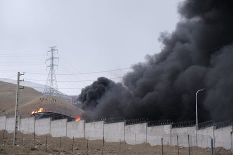 Plumes of smoke rise over oil depot tanks hit by joint Israel-US strikes overnight in a station north west of Tehran, Iran.