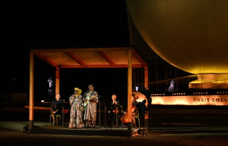 Amadou and Mariam perform beside the Paris 2024 cauldron.