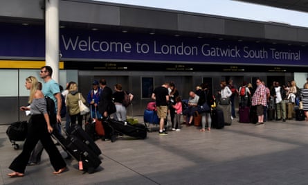 People queue to enter Gatwick airport