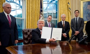 President Trump shows the executive order withdrawing the US from the Trans-Pacific Partnership (TPP).