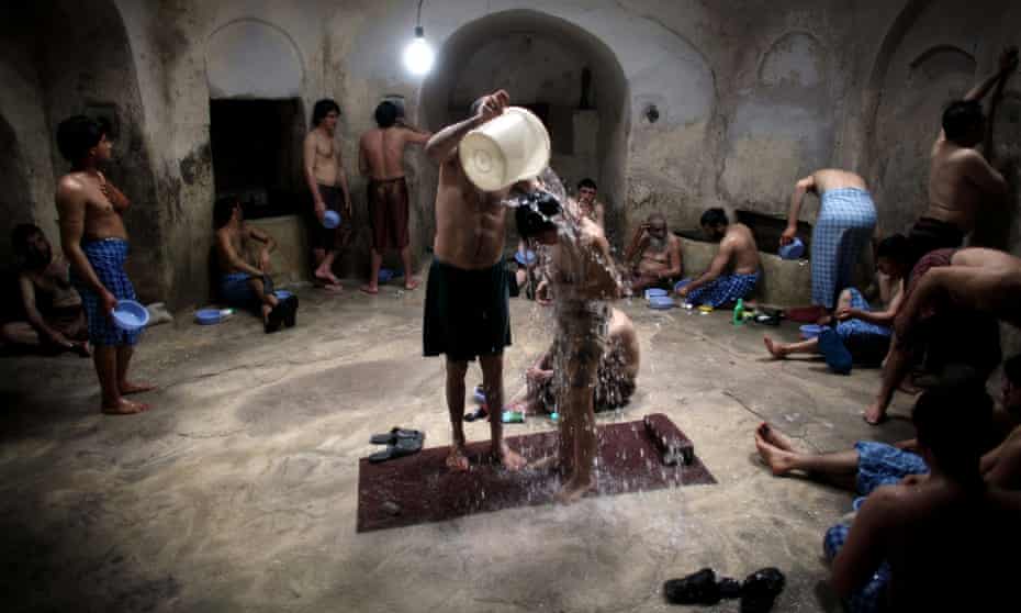 Afghan men and boys wash at a bathhouse in Herat