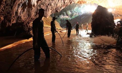 Thai rescue teams arrange water pumping system at the entrance to the cave complex