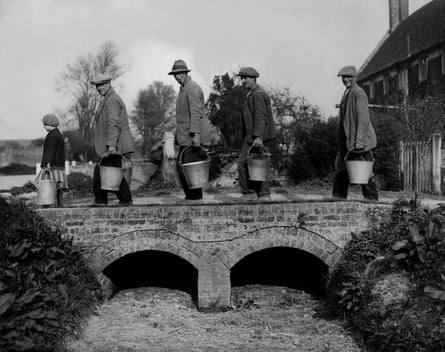 Imber villagers return home with water drawn from a well in 1934.