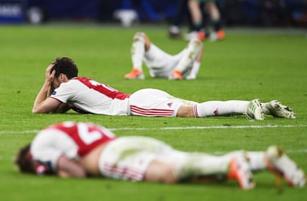 Ajax players lie on the turf in despair after defeat by Tottenham in 2019