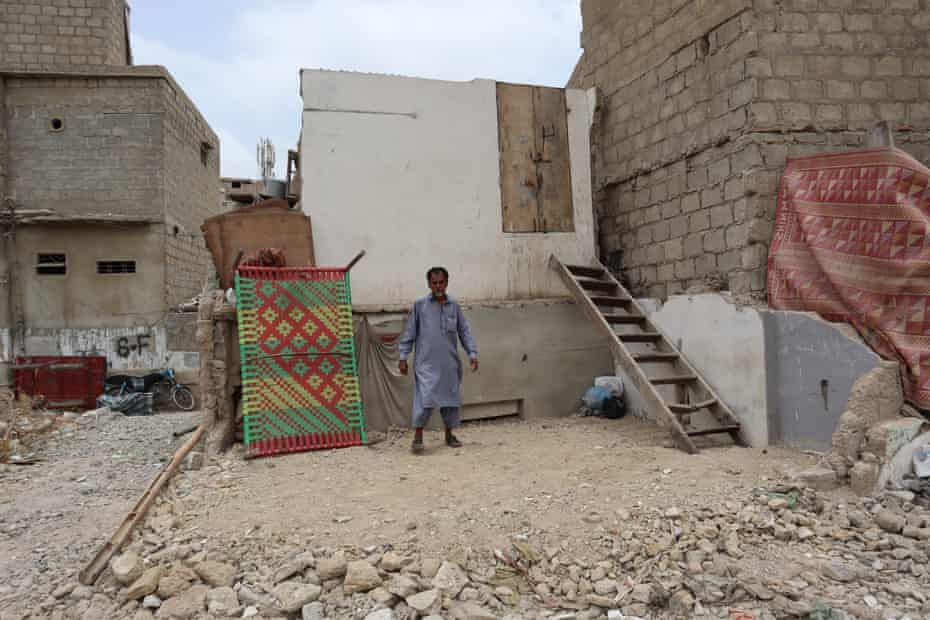 Muhammad Shahid on the rubble where he used to have two rooms that were bulldozed.