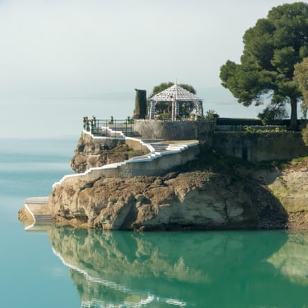 Lakeside House of the Engineer (Casa del Ingeniero) on the turquoise waters of the Embalse del Conde de Guadalhorce, Spain.