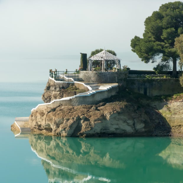 Lakeside House of the Engineer (Casa del Ingeniro) on the turquoise waters of Embalese del Conde de Guadalhorse, Spain.