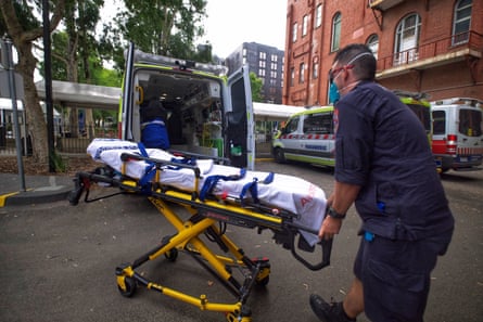 A paramedic moving equipment outside St. Vincent’s Hospital in Melbourne