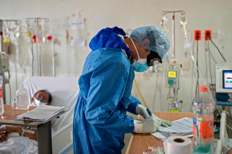 A doctor fills in paperwork for a Covid-19 patient in May 2020.