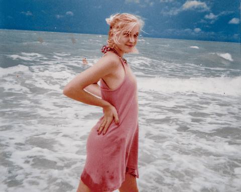 Picture of Virginia Roberts in the sea in a pink dress as a teenager