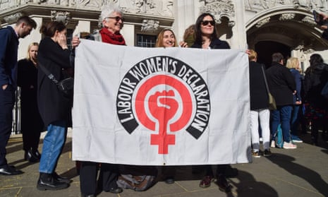 Smiling women hold a campaign banner outside the UK supreme court building