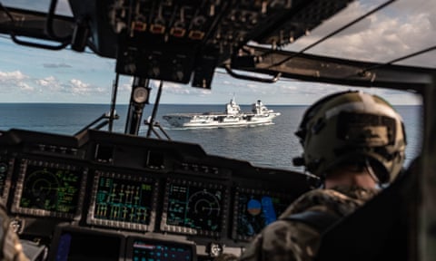 HMS Queen Elizabeth as seen through the cockpit of a Merlin helicopter before landing on the aircraft carrier during trials off the east coast of the USA.