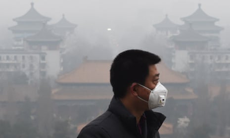 A man wears a mask to protect himself from air pollution in Beijing .