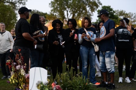Relatives of George Floyd carry candles during a vigil at George Floyd Square on 25 May in Minneapolis, Minnesota.