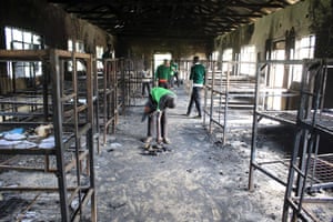Students of St Peter’s Nyamesocho school in Kisii county rummage through a burnt-out dormitory for salvageable items