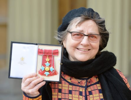 She displays her medal after being made a Dame at an investiture ceremony at Buckingham Palace in 2016