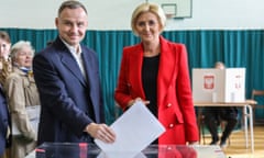 Andrzej Duda and his wife, Agata Kornhauser-Duda, pose while voting at a polling station