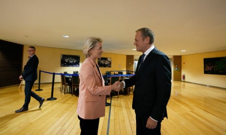 European Commission President Ursula von der Leyen, left, greets leader of the Polish Civic Coalition Donald Tusk at EU headquarters in Brussels, Wednesday, Oct. 25, 2023.