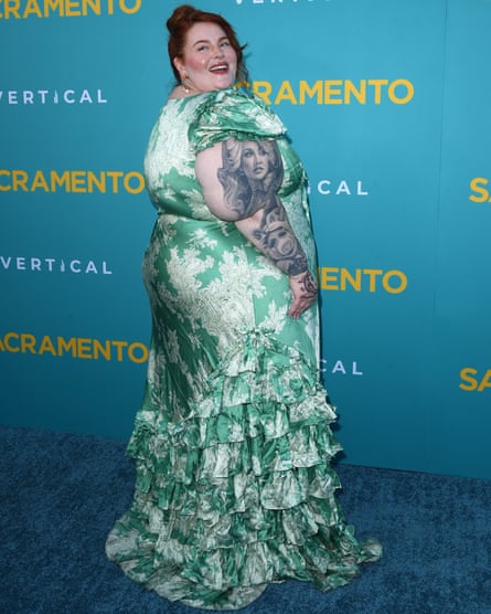 A woman poses on a film screening red carpet
