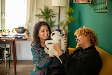 A happy couple with a rabbit pet in their house