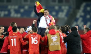 North Macedonia coach Igor Angelovski is lifted into the air by his players.