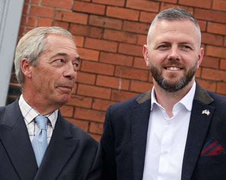 Nigel Farage gazes at Robert Kenyon as they stand side by side